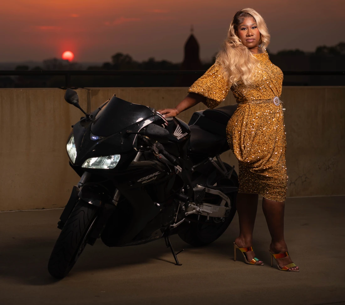 Celebration portrait of a woman in a gold dress at sunset.