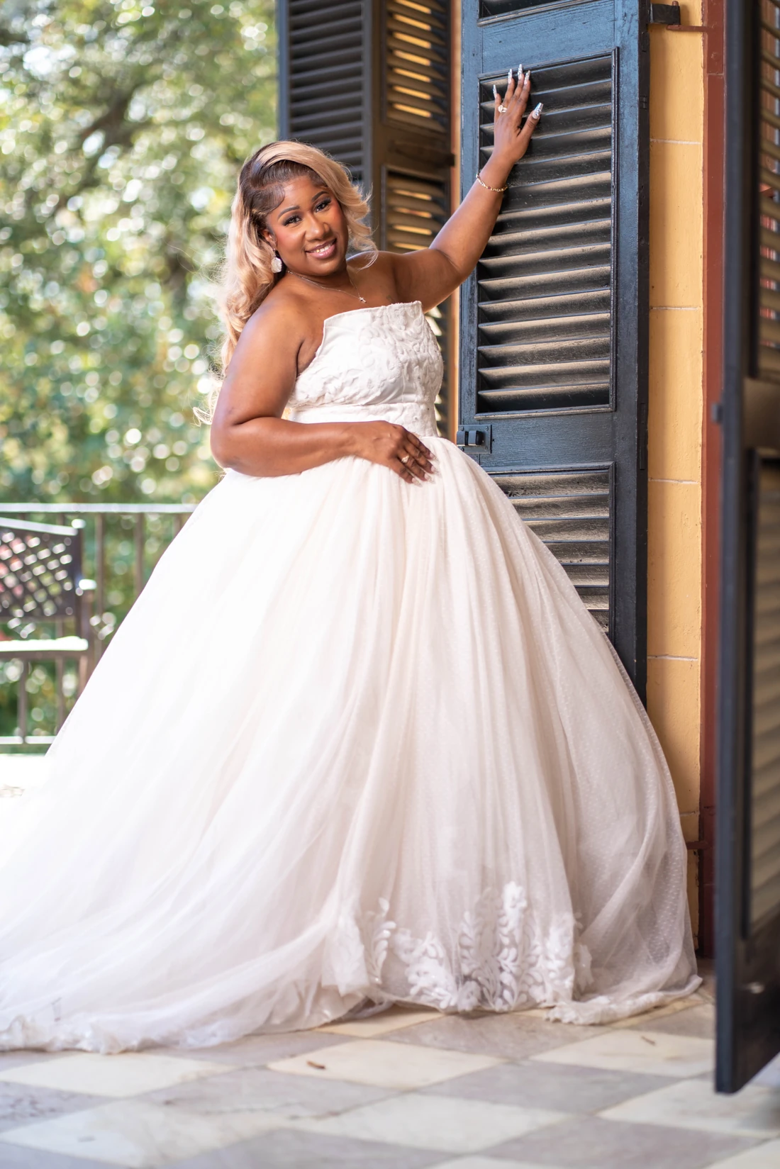 Portrait of a woman wearing a flowing white wedding dress.